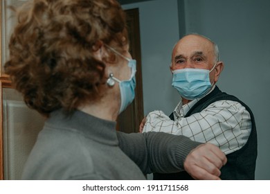 Senior Couple With Face Masks Salute Each Other