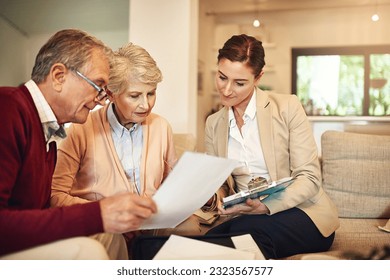 Senior couple, financial advisor and documents for budget, expense or retirement plan on living room sofa at home. Elderly man and woman in finance discussion with consultant, lawyer or paperwork - Powered by Shutterstock