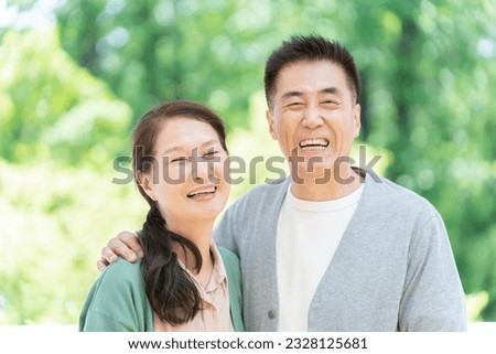 Senior couple with fresh greenery and smiles