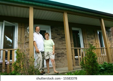 Senior Couple In Front Of Their House