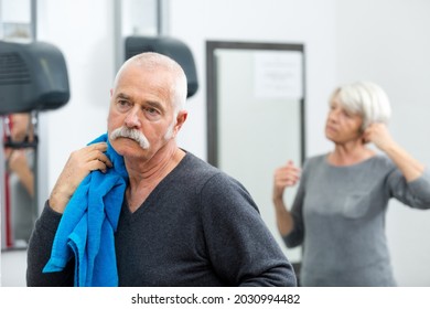 Senior Couple Getting Dressed After Sporting Activity