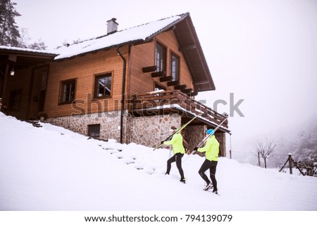 Senior couple going cross-country skiing.