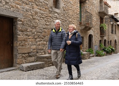 Senior couple going sightseeing in Ainsa, one of the beautiful villages of Spain.