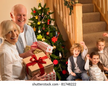 Senior Couple With Grandchildren At Christmas