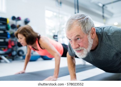 Senior Couple In Gym Working Out, Doing Push Ups