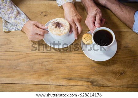 Senior couple having coffee in cafÃ©