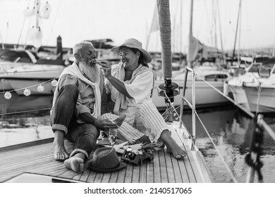 Senior Couple Having Fun Eating Fruits On Sail Boat - Focus On Woman Face - Black And White Editing