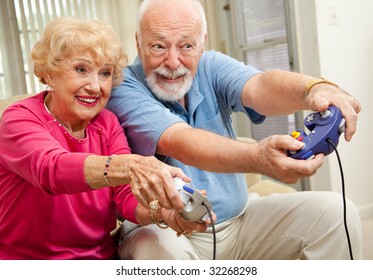 Senior Couple Having Fun Playing Video Games.