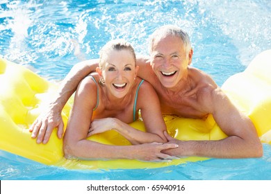 Senior Couple Having Fun In Pool