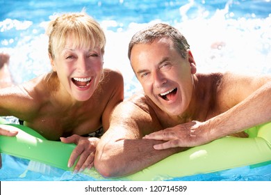 Senior Couple Having Fun In Swimming Pool - Powered by Shutterstock