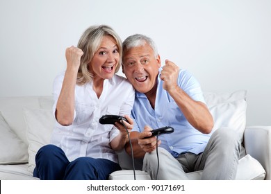 Senior Couple Having Great Time Playing Video Game Together