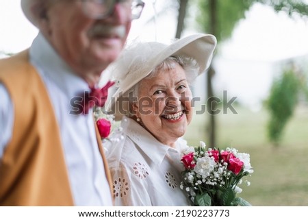 Senior couple having marriage in nature during summer day. Portrait of bride.