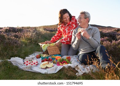 Senior Couple Having Picnic On Countryside Walk - Powered by Shutterstock