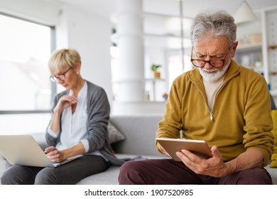 Senior couple having problems with technology devices at home