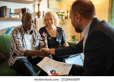 Senior couple having serious financial discussion with advisor at home - Powered by Shutterstock