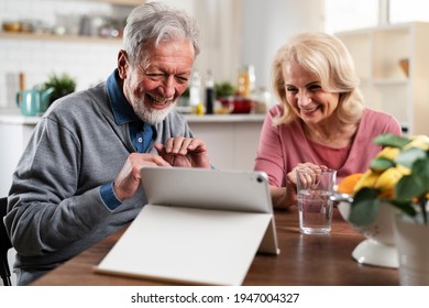 Senior Couple Having Video Call. Happy Husband And Wife Talking With Their Grandkids.