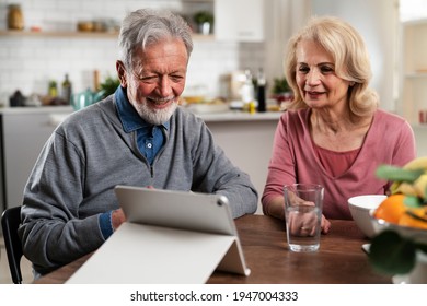 Senior Couple Having Video Call. Happy Husband And Wife Talking With Their Grandkids.