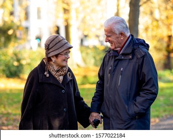 A Senior Couple Having A Walk In Hyde Park, London. Autumn.