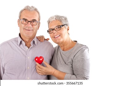 Senior Couple With Heart In Front Of White Background