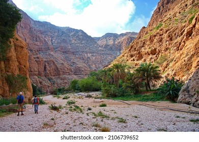 Senior couple hiking along Wadi Shab in Oman - Powered by Shutterstock