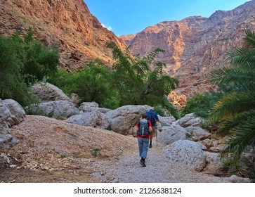 Senior couple hiking along Wadi Shab in Oman - Powered by Shutterstock