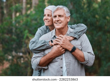 Senior couple, hiking and hug outdoor in nature for exercise, fitness and trekking for health and wellness. Old man and woman thinking, care and smile on forest hike for cardio workout in retirement - Powered by Shutterstock