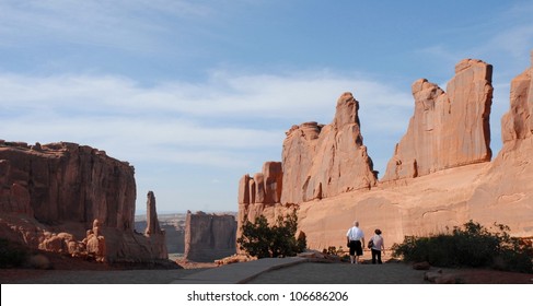 Senior Couple Hiking At Park Avenue, Arches National Park, Utah USA