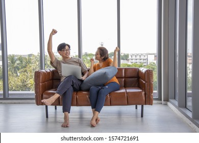 Senior Couple At Home , Enjoying Spending Time Together. Living Room Background. Generation Modern Technology Retirement Romantic Healthy Concept. Asian Middle Age.Success Sign Positive Winner Gesture