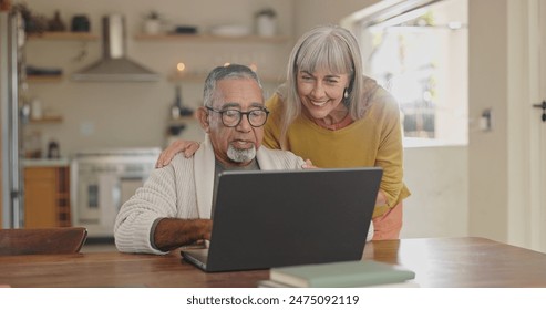 Senior couple, home and laptop for internet research with for retirement and social media update. Interracial marriage, old man and woman with computer in kitchen for video call app and virtual chat - Powered by Shutterstock