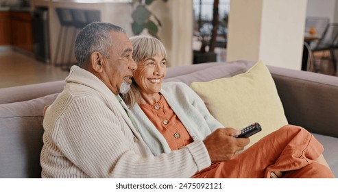 Senior couple, home and remote for watching tv with retirement and streaming movie together. Interracial marriage, old man and woman on couch with change channel or click for online series with relax - Powered by Shutterstock