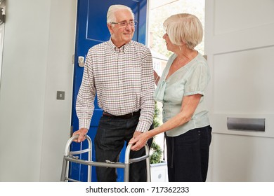 Senior Couple At Home Talking, Man Using A Walking Frame