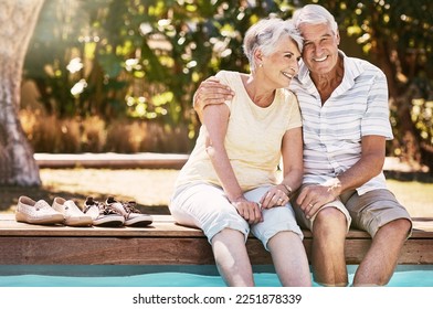 Senior couple, hug and swimming pool for summer vacation, love or relax spending quality bonding time together. Happy elderly man holding woman relaxing with feet in water by the poolside outside - Powered by Shutterstock