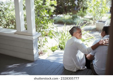 Senior couple hugging on porch - Powered by Shutterstock