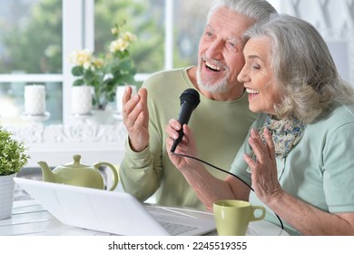 senior couple husband and wife singing songs - Shutterstock ID 2245519355