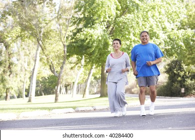 Senior Couple Jogging In Park