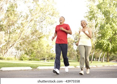 Senior Couple Jogging In Park