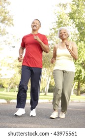 Senior Couple Jogging In Park