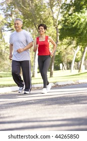 Senior Couple Jogging In Park