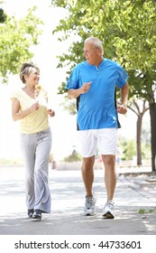 Senior Couple Jogging In Park