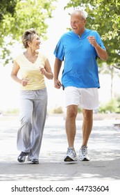 Senior Couple Jogging In Park