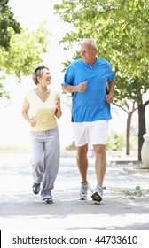 Senior Couple Jogging In Park