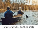 Senior couple, kayak and rowing in river for holiday, travel or summer vacation in water outdoor together. Man, woman or canoe boat in lake on transport for adventure, exercise or back view in nature