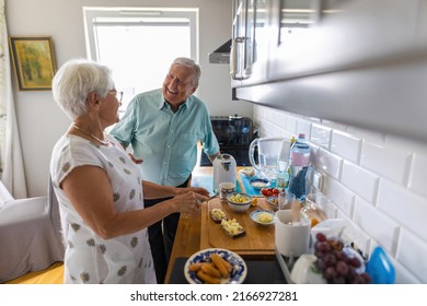 Senior Couple In A Kitchen Making Breakfast 
