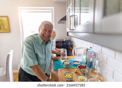 Senior Couple In A Kitchen Making Breakfast 
