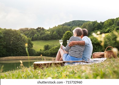 Senior couple at the lake having a picnic - Powered by Shutterstock