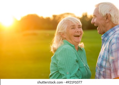 Senior Couple Laughing. Man And Woman Outdoors. Sense Of Humour. Old Funny Jokes.