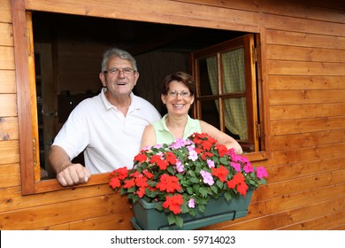 Senior Couple In Log Cabin