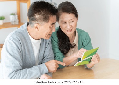 Senior couple looking at bankbook