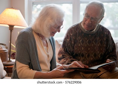 Senior Couple Looking Through Photo Album