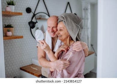 Senior Couple In Love In Bathroom, Looking At Mirror And Smiling, Morning Routine Concept.